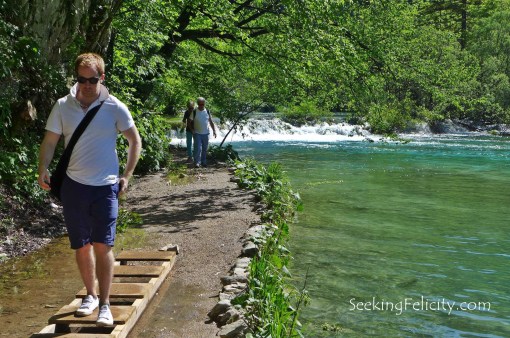 Making sure he doesn't get his shoes wet. 